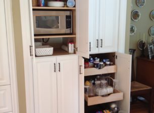 This picture shows how the deep closet space was utilized more efficiently and made to appear to be part of the cabinetry at the same time. The deep Pull out trays provide easy access to stored items.