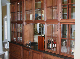 This cabinet was accessible from both the kitchen side (shown) and the living room side. The cabinet was designed to serve as a divider between the kitchen and the living room. Glass doors on both sides maintain visibility between the rooms.