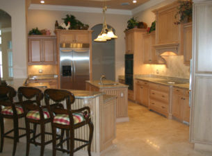 Mitered doors and beadboard panels were included in this design. This kitchen was made utilizing soft maple which was stained with a frost stain and then glazed with Van Dyke Brown glaze.