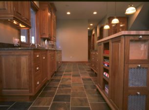 This incredible kitchen was made using steamed select cherry. Commodity bins @ the island end allow for onion and potato storage. The top glass drawer has a bulkhead that can be filled w/ beans or M&Ms! and allows storage behind!