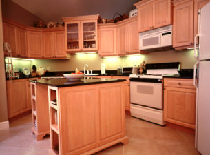 This is a remodeled kitchen which originally was outfitted with laminate cabinets with soffits above. The soffits were removed which enabled stepping up of certain cabinets. Breaking up monotonous horizontal lines can enhance the design.