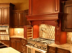 This custom designed range hood features pull outs which flank both sides of the stove. Spices, cooking oil and perhaps the chef's secret ingredients can be stored inside!