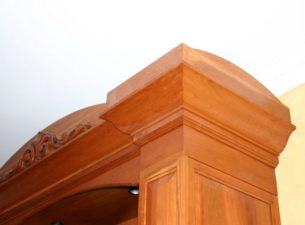 This cornice/ Crown molding was made by combining several molding profiles and embellished with an Enkebol onlay. The cabinet was made from steamed cherry and is finished with a Van Dyke glaze with light distressing.