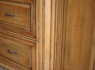 Applied molding is utilized on the radius corner which creates the "bump out" on this Master Bath Vanity. Notice the Furniture skirt follows the countour of the cabinet and is reflected in the shape of the granite top. Tulip Bun Feet  are shown here.