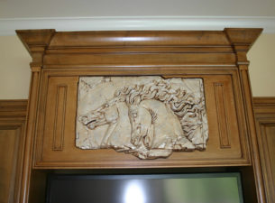 Our Client provided the relief sculptured horse head artwork and we actually built this section of the Entertainment Center around it. The original artwork was glazed with the same glaze used in the Cabinetry to help blend it in.