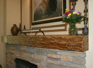 This custom angled Fireplace Mantle Beam was fabricated from soft maple boards. All the exposed edges were mitred together so as to make it appear to be hewn from one single piece of wood. Distressing and finishing was then done at the shop.