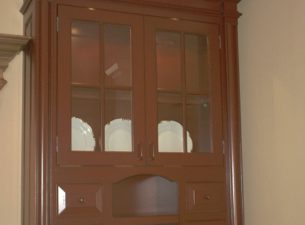 This cabinet which is different in design from the main portion of the kitchen with respect to both design and finish serves as an accent piece in the Kitchen. Notice the intricate molding applications both at the top and bottom.