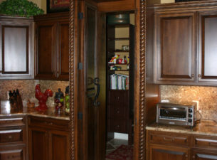 The trash pull out has been face with drawer fronts to maintain the balance to the left and right of the stove.
