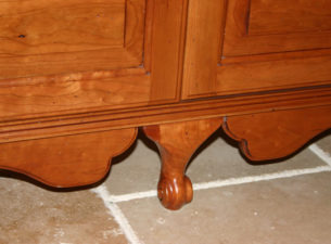 Same armoire cabinet. Close up of base detail. Furniture skirt with Queen Anne leg and flanking furniture apron.